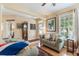 Warm living room with hardwood floors, ample natural light, and comfortable seating arrangement at 206 Norfolk Pl, Celebration, FL 34747