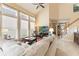 Bright living room with high ceilings, large windows, neutral tones, and staircase at 206 Norfolk Pl, Celebration, FL 34747