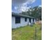 Exterior view of home featuring fenced backyard and mature trees, offering a private outdoor space at 2071 Liston Ct, Orlando, FL 32811