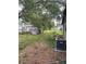 Spacious backyard featuring shade trees, an AC unit, and partial fencing at 2071 Liston Ct, Orlando, FL 32811