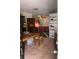 Dining room with tiled floor, a dining table and chairs, and built-in shelves and access to the kitchen at 2071 Liston Ct, Orlando, FL 32811