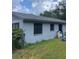 Exterior view of a home with light-blue siding and dark trim on a grassy lot at 2071 Liston Ct, Orlando, FL 32811