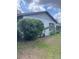 Home exterior with a well established bush and a small palm tree at 2071 Liston Ct, Orlando, FL 32811