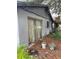 Exterior view of the back of the house featuring sliding glass door, vegetation and two flower pots at 2071 Liston Ct, Orlando, FL 32811