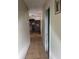 Long hallway featuring neutral walls and tiled flooring leading to various rooms at 2071 Liston Ct, Orlando, FL 32811