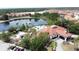Breathtaking aerial view of the lake, community pool, lush landscaping, and clubhouse at 219 Rosso Dr, Davenport, FL 33837
