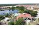 Stunning aerial view shows community pool, lake, clubhouse, and surrounding mature landscaping at 219 Rosso Dr, Davenport, FL 33837