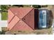 High angle shows a lovely terracotta roof and enclosed backyard pool with lush landscaping at 219 Rosso Dr, Davenport, FL 33837