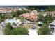 Community clubhouse and pool area surrounded by palms and playground in a residential neighborhood at 219 Rosso Dr, Davenport, FL 33837