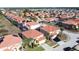 An aerial shot shows a charming residential area with terracotta roofs and lush vegetation at 219 Rosso Dr, Davenport, FL 33837