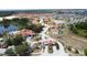 Community aerial showcases the lake, entry gate, and clubhouse surrounded by lush landscaping at 219 Rosso Dr, Davenport, FL 33837