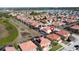 Aerial photo of a neighborhood, highlighting homes with orange roofs and enclosed pools at 219 Rosso Dr, Davenport, FL 33837