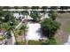 Overhead view of the community sand volleyball court surrounded by palm trees, grass, and sidewalks at 219 Rosso Dr, Davenport, FL 33837