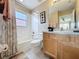A full bathroom features a shower and tub, a large mirror and a single vanity and toilet at 219 Rosso Dr, Davenport, FL 33837