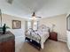 Relaxing bedroom featuring stylish wrought iron bed frame and a ceiling fan for added comfort at 219 Rosso Dr, Davenport, FL 33837