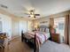 Charming bedroom with ceiling fan, large windows, and comfortable bed at 219 Rosso Dr, Davenport, FL 33837
