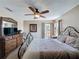 Spacious bedroom with a wrought iron bed frame, dresser, and a window for natural light at 219 Rosso Dr, Davenport, FL 33837