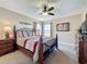 Spacious bedroom featuring a ceiling fan, windows, and a comfortable bed at 219 Rosso Dr, Davenport, FL 33837