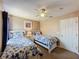 This cozy bedroom features two beds with ceiling fan and a lovely color scheme at 219 Rosso Dr, Davenport, FL 33837