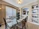 Dining room with glass table, iron chairs, and built in shelves for decorative items adds modern elegance at 219 Rosso Dr, Davenport, FL 33837