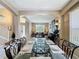 Open floor plan showcases the dining room with glass table, metal chairs, and access to the living room and entry at 219 Rosso Dr, Davenport, FL 33837