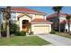 Inviting two-story home with a terra-cotta tiled roof, attached garage, and well-maintained front yard at 219 Rosso Dr, Davenport, FL 33837