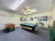 Game room features a pool table, foosball table, bar with stools, and decorated walls at 219 Rosso Dr, Davenport, FL 33837