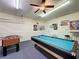 Game room features a pool table, foosball table, a bar with stools, and bright lighting at 219 Rosso Dr, Davenport, FL 33837