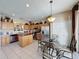Kitchen with stainless steel appliances, central island, and breakfast nook with seating for casual dining experiences at 219 Rosso Dr, Davenport, FL 33837