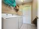 Laundry room featuring modern washer and dryer, tile floor, and plenty of room at 219 Rosso Dr, Davenport, FL 33837
