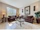 Comfortable living room with stylish furnishings, natural light, tile floors, and a decorative wall accent at 219 Rosso Dr, Davenport, FL 33837
