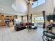 Open concept living room connects kitchen, dining, and living spaces with high ceilings and access to outdoor living at 219 Rosso Dr, Davenport, FL 33837