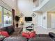 Living room with high ceilings, glass coffee tables, decorative metal accents, and sliding doors to the patio at 219 Rosso Dr, Davenport, FL 33837