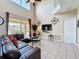 Living room features high ceilings, a ceiling fan, sliding doors to the patio, and a view of the backyard at 219 Rosso Dr, Davenport, FL 33837