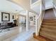 Inviting living room featuring tile floors, a staircase, and an open layout with views of the dining and kitchen areas at 219 Rosso Dr, Davenport, FL 33837