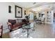 Bright and airy living area with tile floors, cozy seating, and a view of the dining area and built-in shelving at 219 Rosso Dr, Davenport, FL 33837