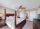 This main bedroom features a ceiling fan, neutral walls, and ensuite bath for convenience and privacy at 219 Rosso Dr, Davenport, FL 33837