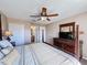 This main bedroom features a ceiling fan, neutral walls, and adjoins a bathroom and closet for convenience and privacy at 219 Rosso Dr, Davenport, FL 33837