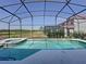 Inviting pool and spa in a screened enclosure, offering a private outdoor oasis at 219 Rosso Dr, Davenport, FL 33837