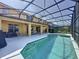 Relaxing screened-in pool featuring pristine water, plenty of lounging space, and a beautiful backyard at 219 Rosso Dr, Davenport, FL 33837