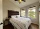 Cozy bedroom with natural lighting, wood floors, and decorative headboard at 2287 Park Maitland Ct, Maitland, FL 32751