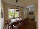 Bright dining room featuring wood floors, a modern light fixture, and views of the backyard at 2287 Park Maitland Ct, Maitland, FL 32751