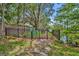 Fenced dog park area with lush foliage and signage at 2287 Park Maitland Ct, Maitland, FL 32751