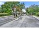 Gated entrance to the community with manicured landscaping and mature trees at 2287 Park Maitland Ct, Maitland, FL 32751