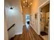 Inviting hallway with wood floors and staircase leads to bathroom and bedrooms at 2287 Park Maitland Ct, Maitland, FL 32751