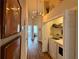 Bright hallway with wood floors leading to a laundry room featuring modern washer and dryer at 2287 Park Maitland Ct, Maitland, FL 32751