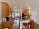 Modern kitchen with granite countertops, wood cabinets, and an open layout connecting to the dining area at 2287 Park Maitland Ct, Maitland, FL 32751