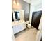 Modern bathroom featuring a vanity, toilet, tiled floor, and dark shower curtain at 2386 Rama Dr, Kissimmee, FL 34746
