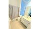 Well-lit bathroom with a shower/tub combination, white vanity, and decorated walls at 2386 Rama Dr, Kissimmee, FL 34746