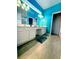 Spacious bathroom with double sinks, white cabinetry, and tiled floors at 2386 Rama Dr, Kissimmee, FL 34746